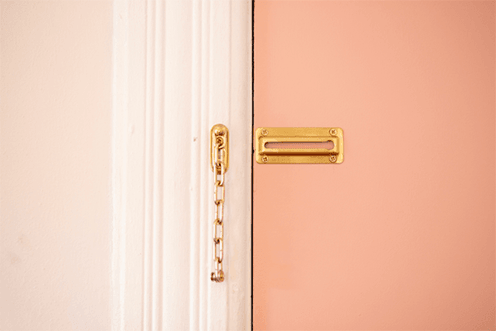 Pink door with gold chain lock Pink door with gold chain lock