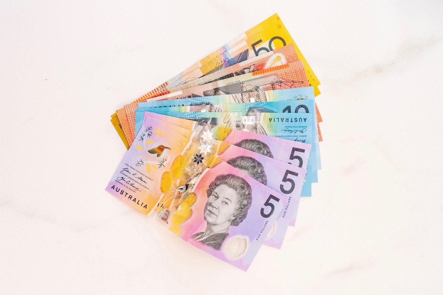 Australian dollars fanned out on marble background