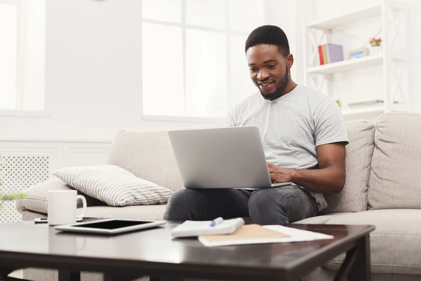 Man sitting on a sofa with his laptop
