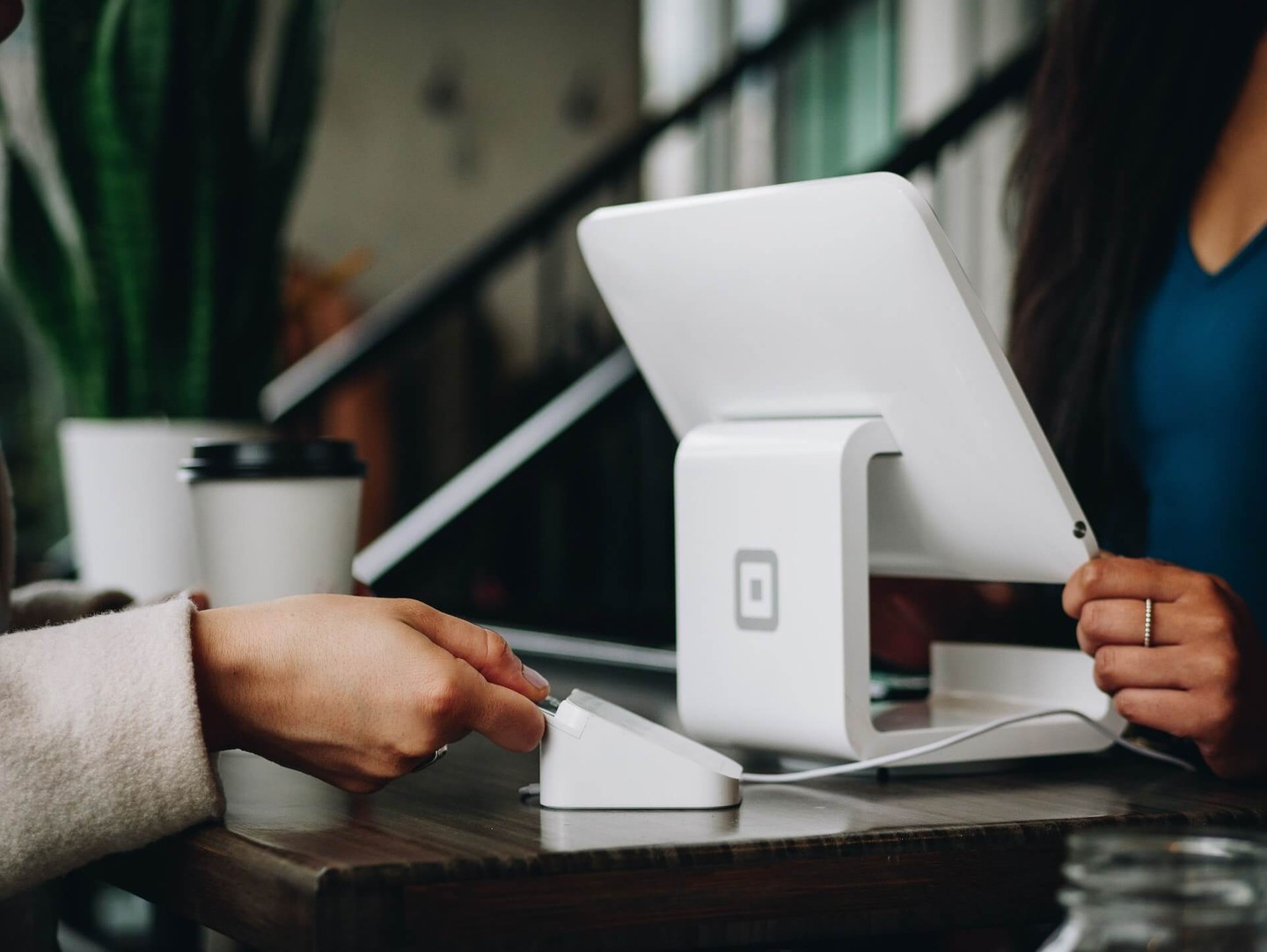 Woman paying for something with a credit card Woman paying for something with a credit card