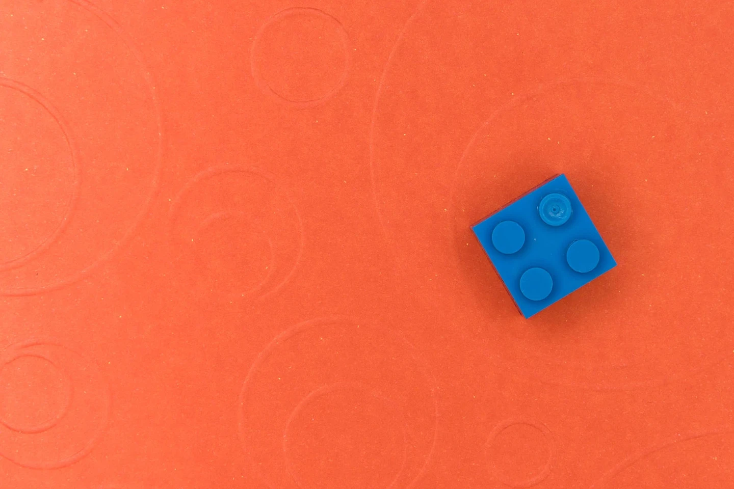 One Lego block on a surface