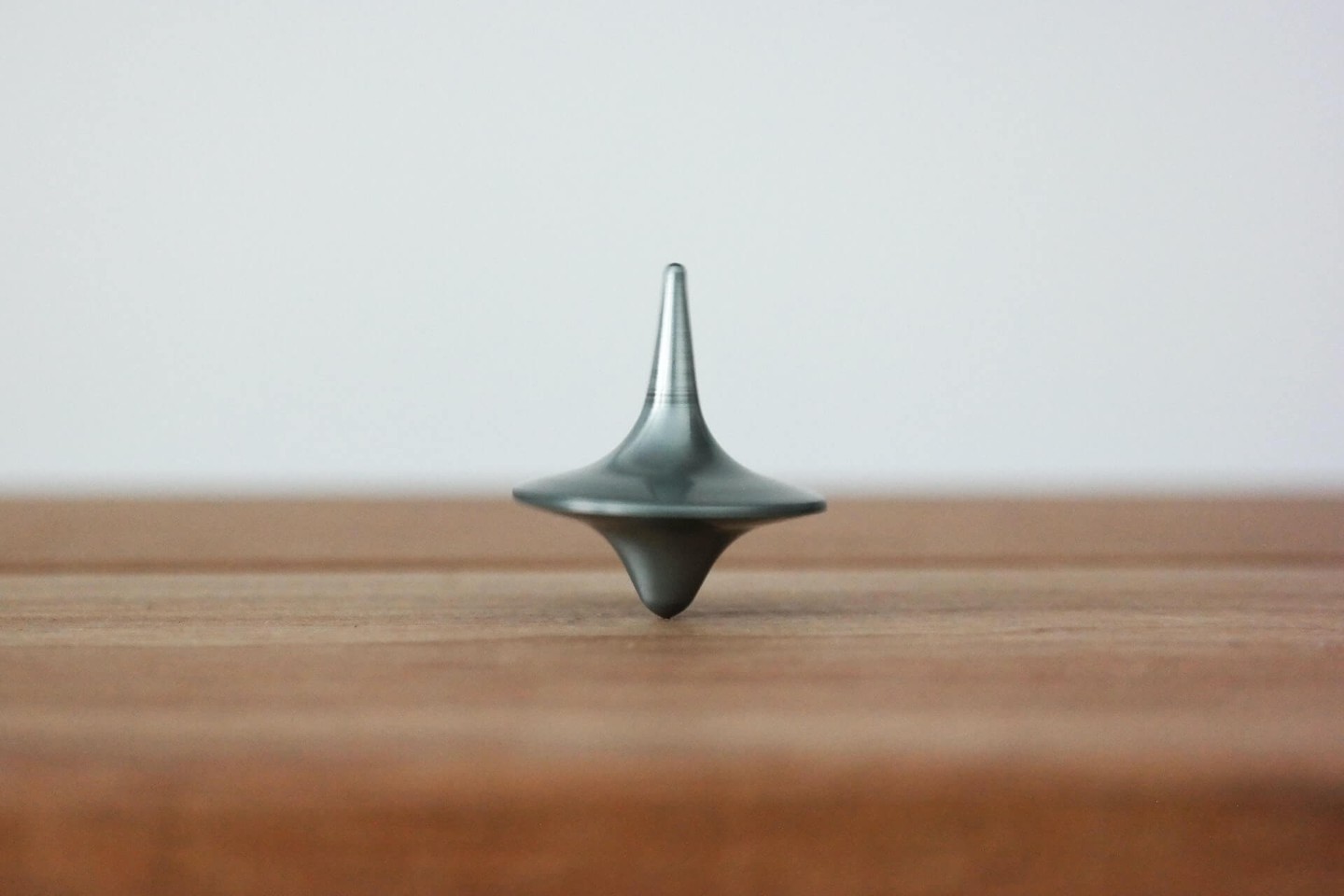 Spinning top balancing on a desk