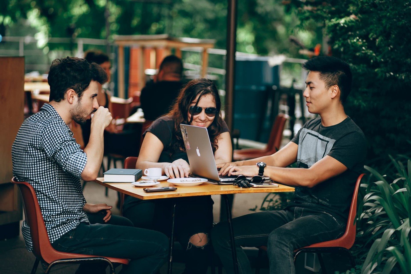 Young people have coffee outside, with laptop Young people have coffee outside, with laptop