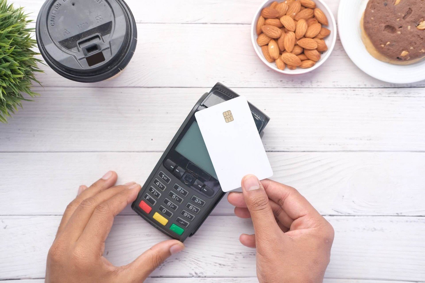 Person holding credit card against card reader