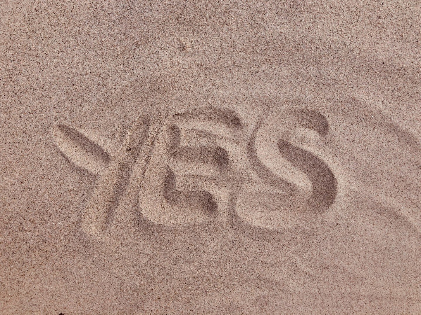 YES written in the sand