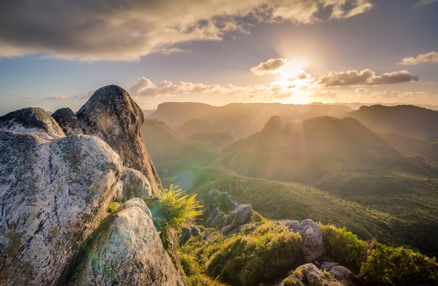 Sun rays shining over mountain landscape Sun rays shining over mountain landscape
