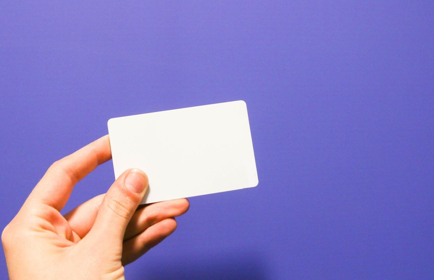 Someone holding a blank credit card Someone holding a blank credit card