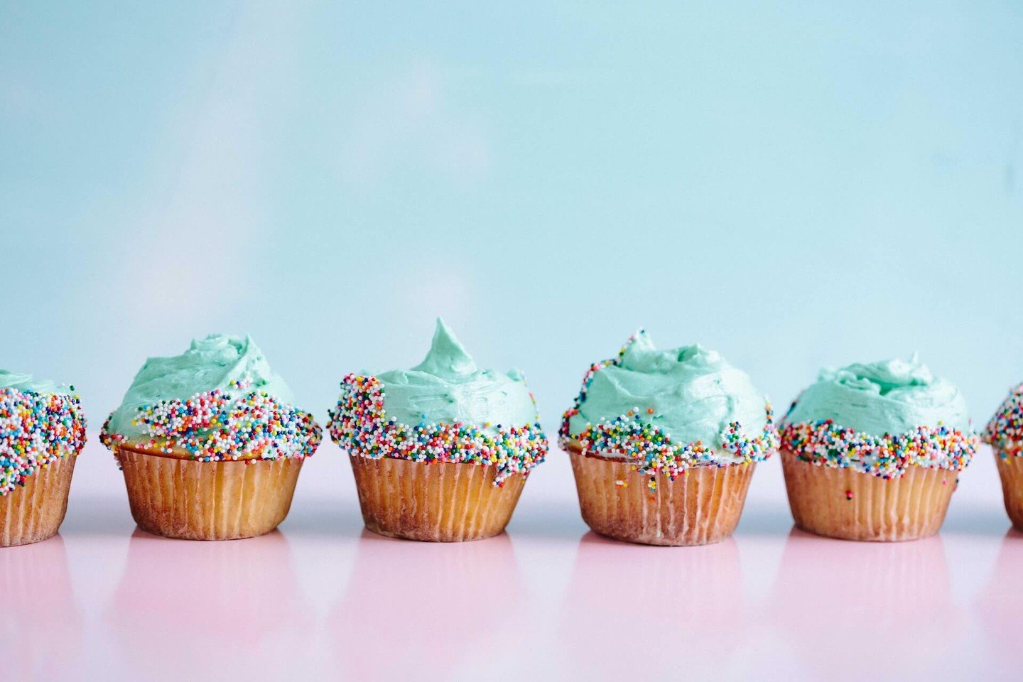 A row of iced cupcakes