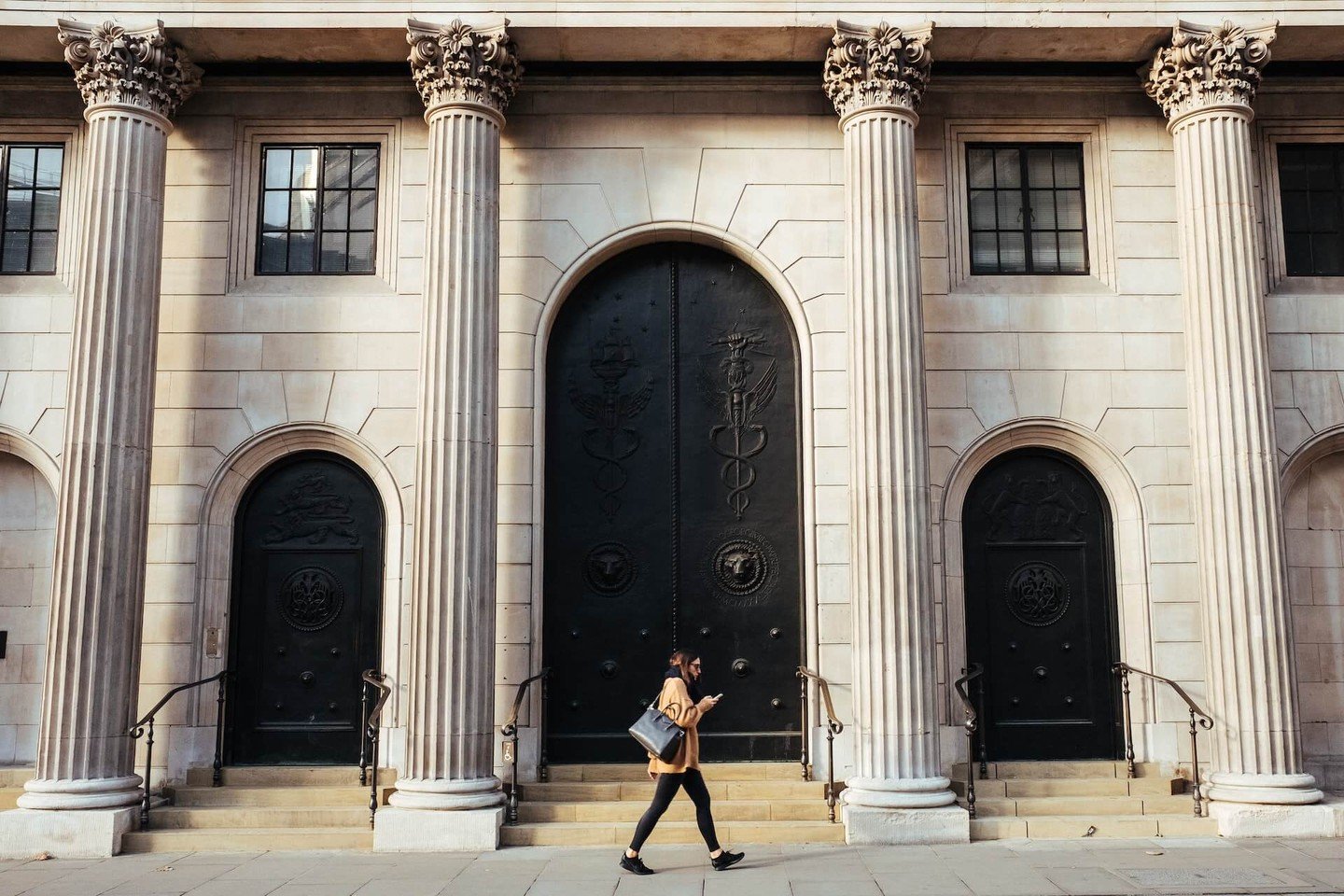 Woman walks past bank