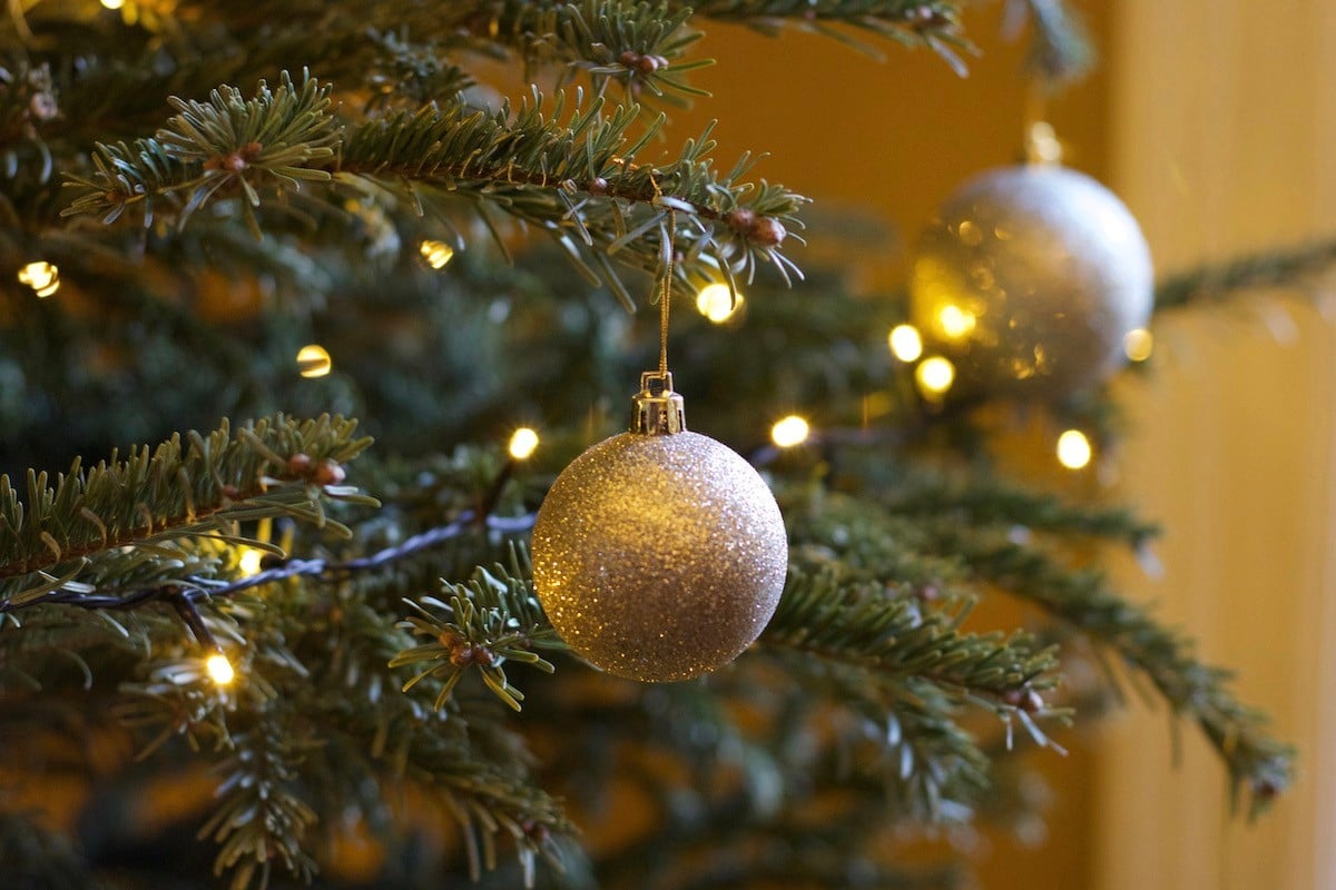 Gold bauble on a Christmas tree Gold bauble on a Christmas tree