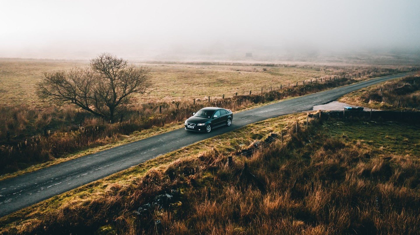 car driving through field 