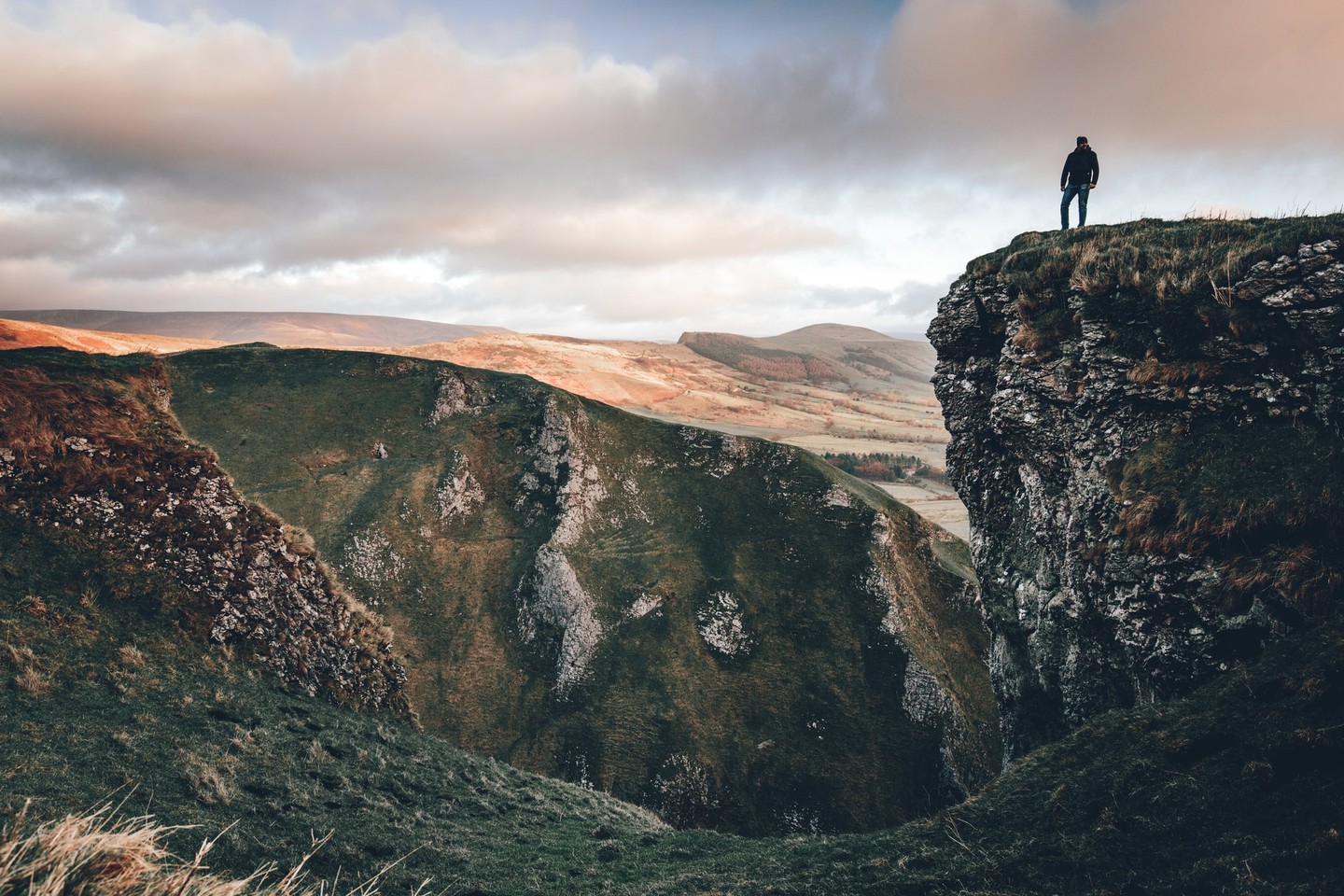 Man stands on peak in Peak District