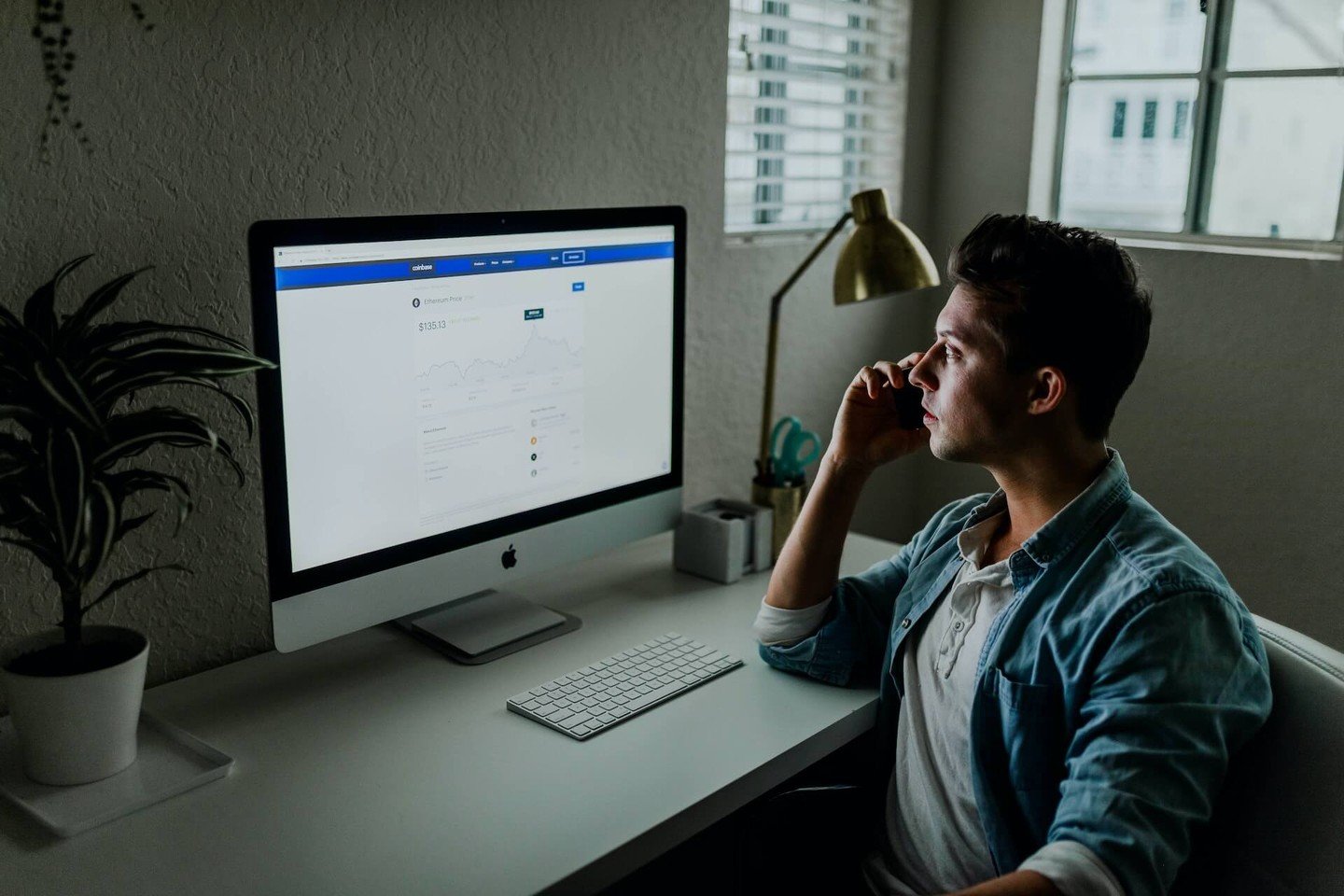 Man sitting at desk looking at his computer Man sitting at desk looking at his computer