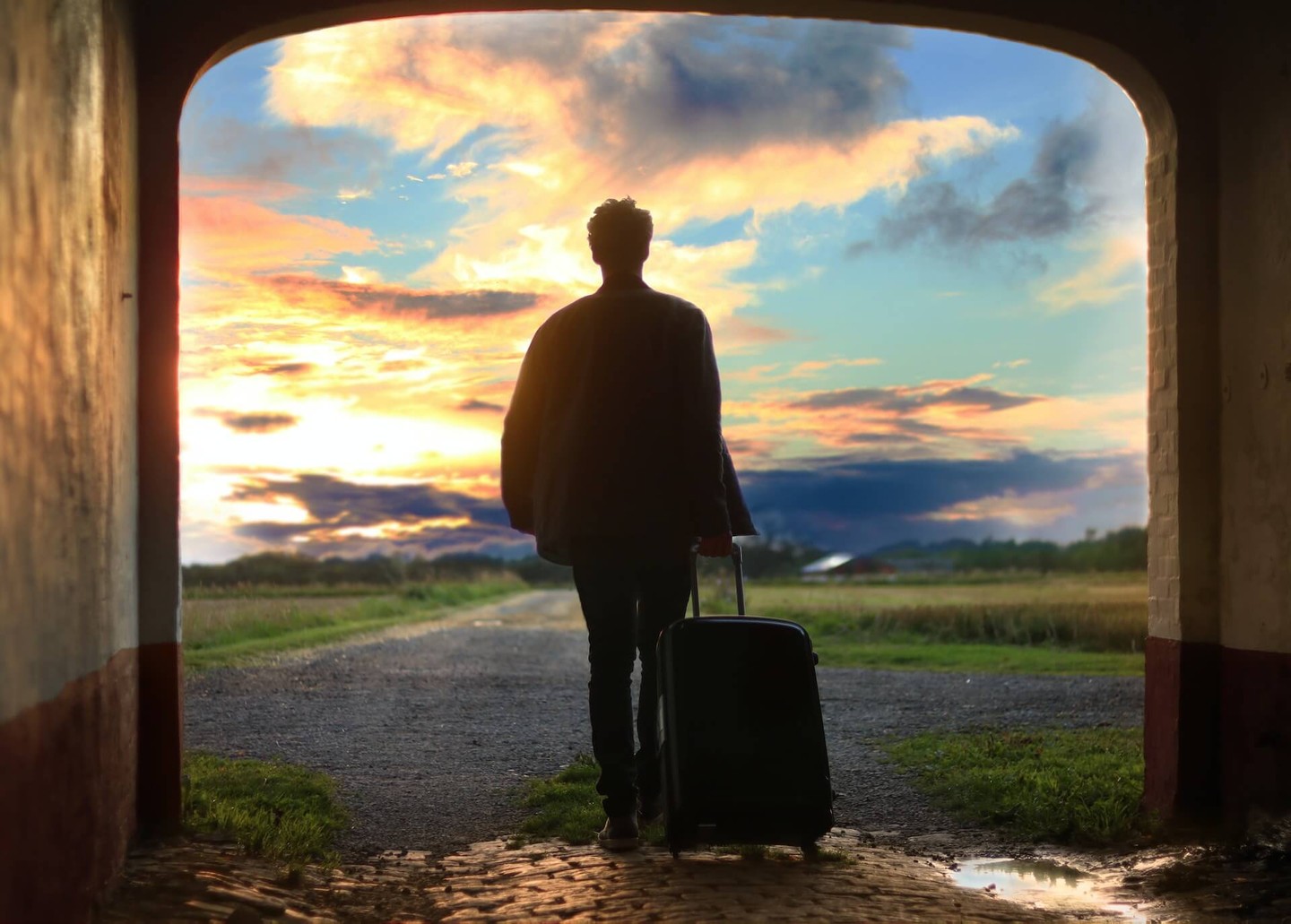 Person with a suitcase walking out of a doorway Person with a suitcase walking out of a doorway