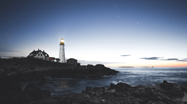 Lighthouse surrounded by sea and rocks