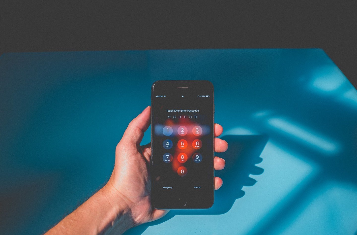 iPhone with passcode on blue background iPhone with passcode on blue background