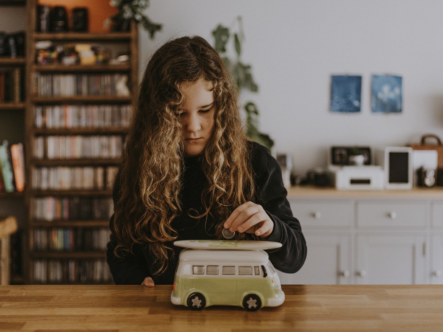 Saving money into surfer piggy bank Saving money into surfer piggy bank