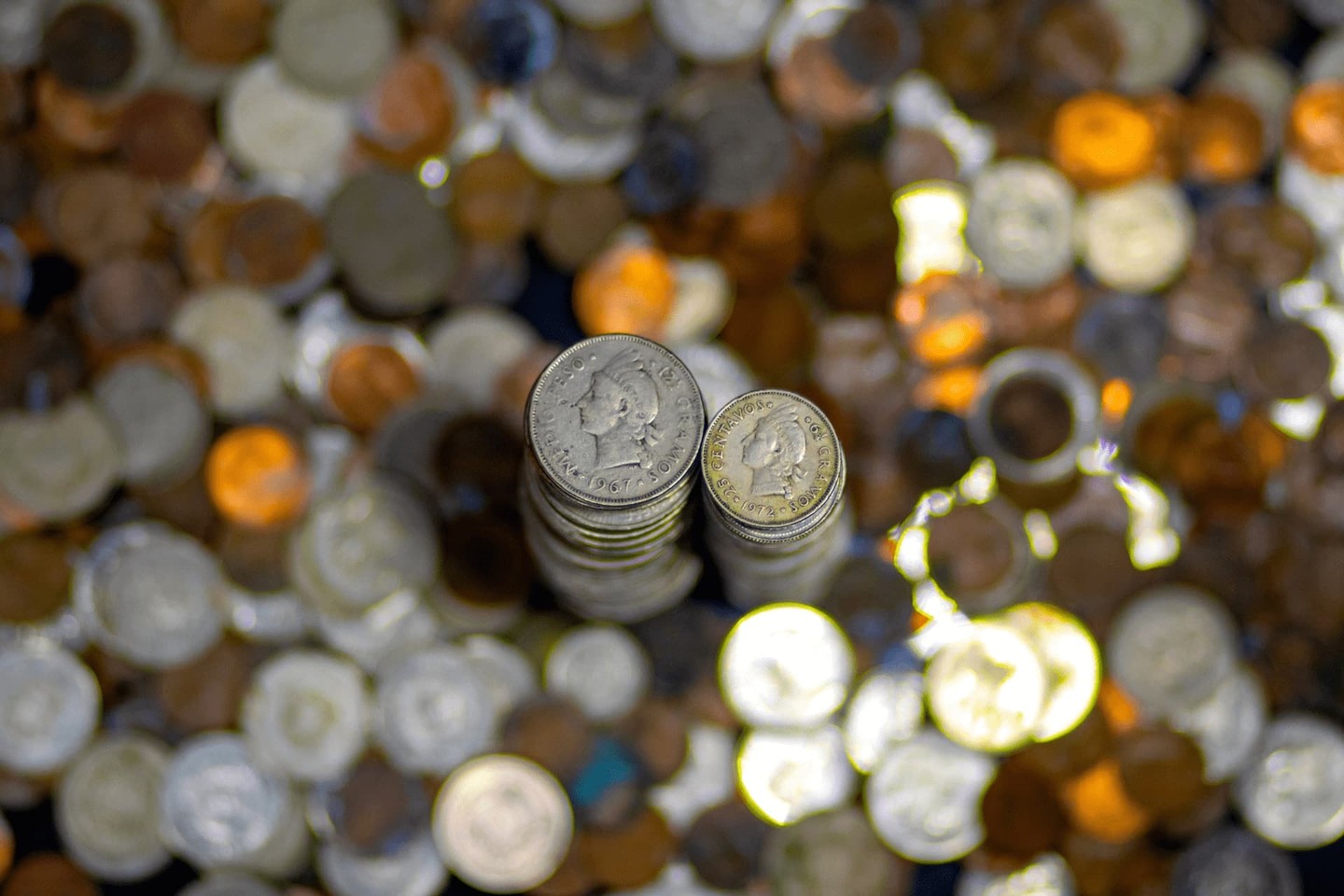 Piles of coins with blurry coins in background