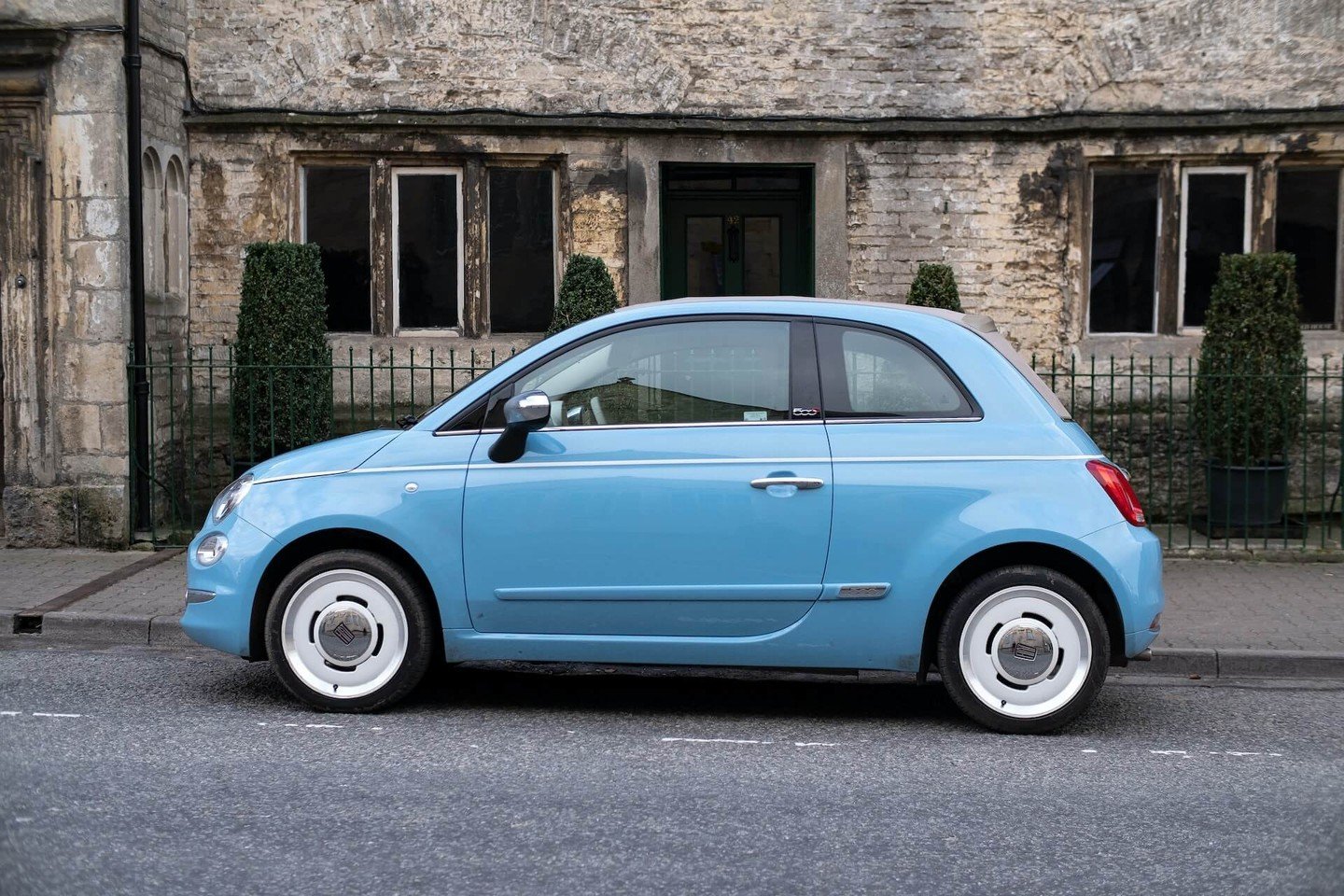Fiat 500 car in front of old building Fiat 500 car in front of old building