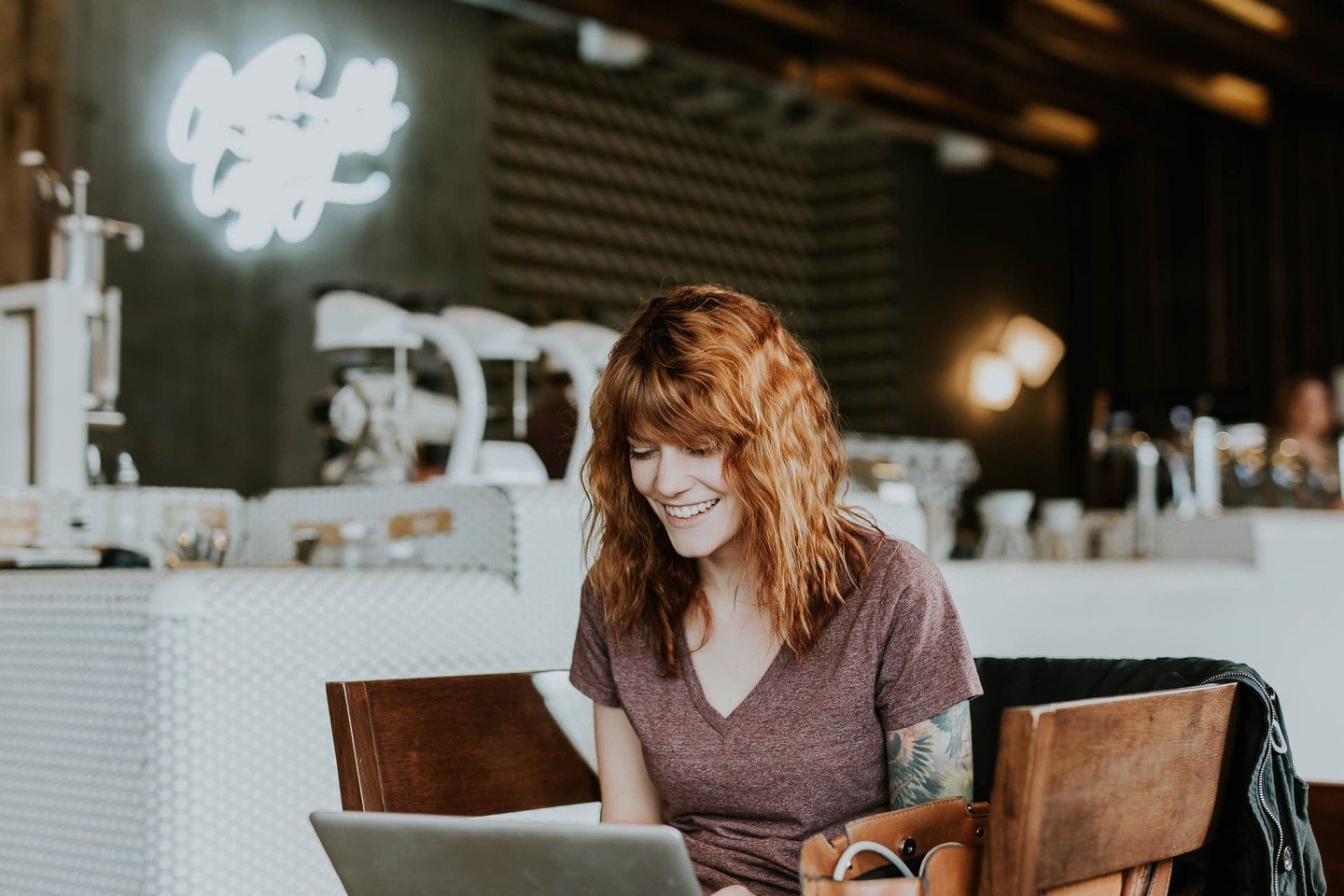 Lady smiling in cafe with laptop Lady smiling in cafe with laptop