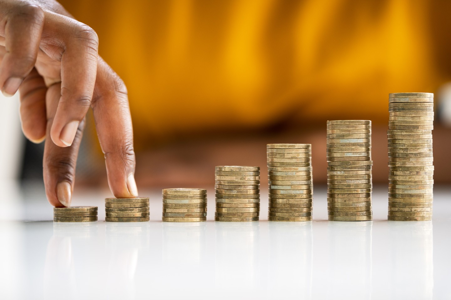 A person placing their fingers over coins. A person placing their fingers over coins.