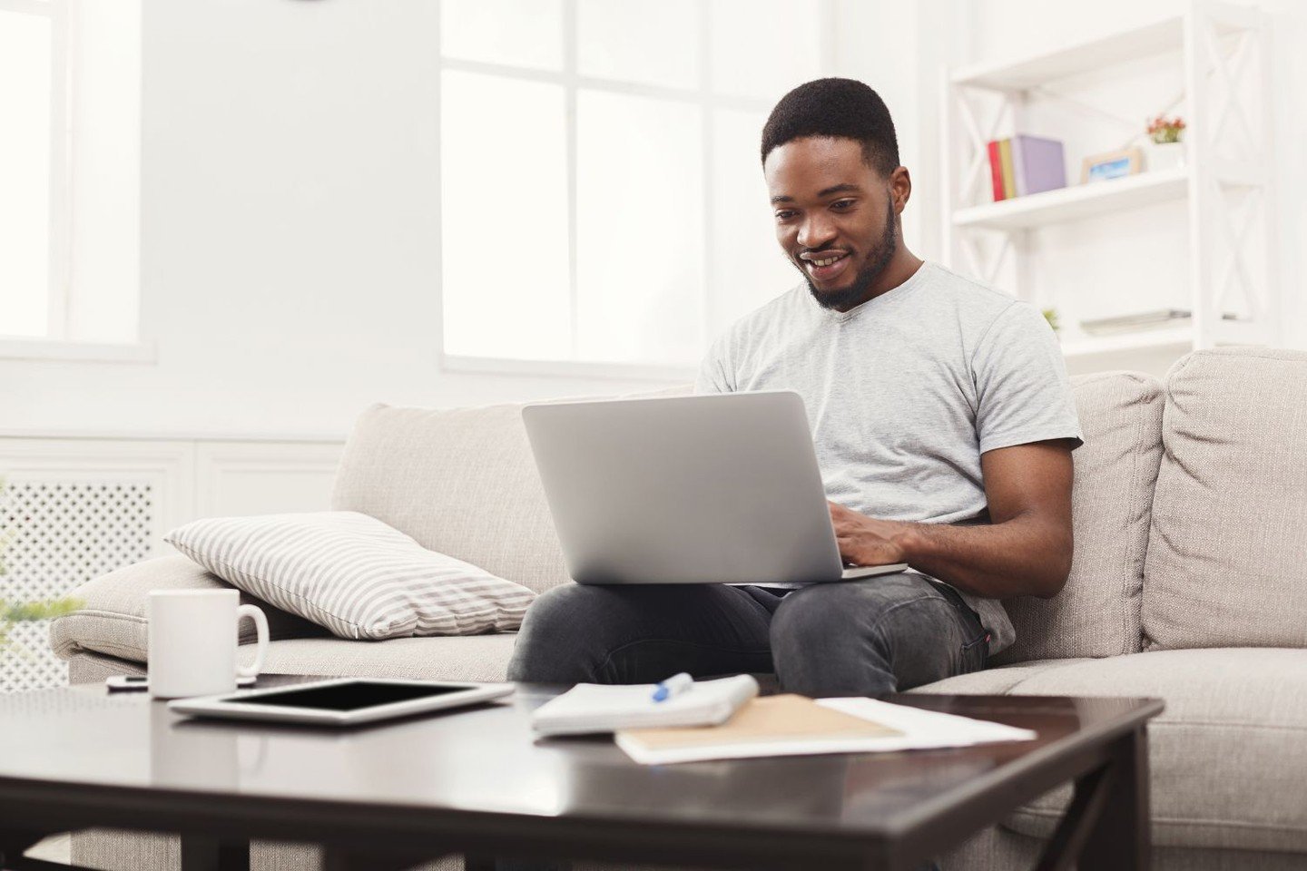 Man reads text on laptop screen