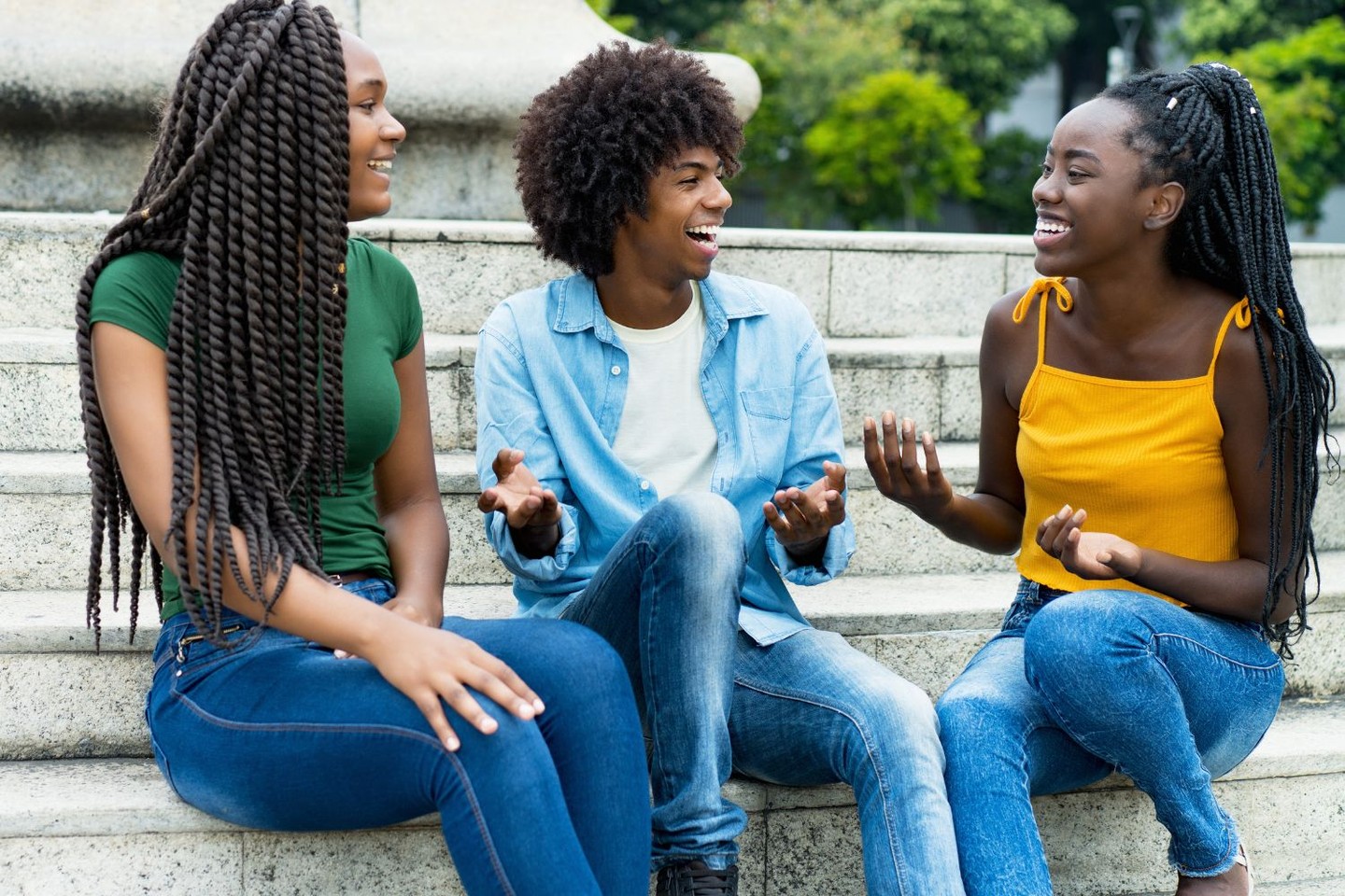 Young people having a conversation while sitting on steps Young people having a conversation while sitting on steps
