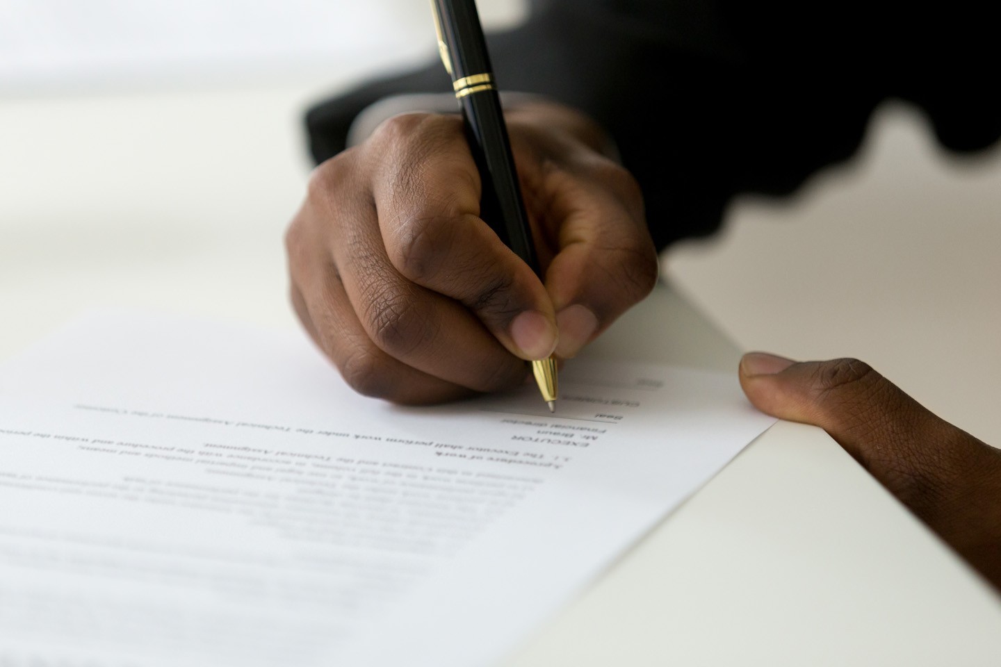Person filling in an application form. Person filling in an application form.