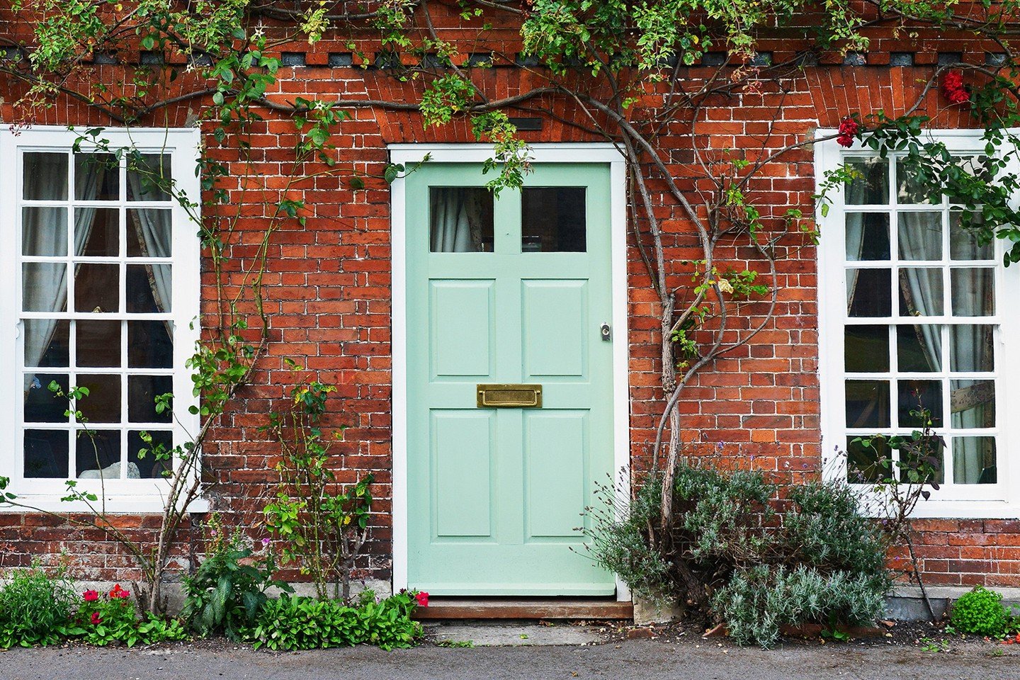 Green front door of brick house