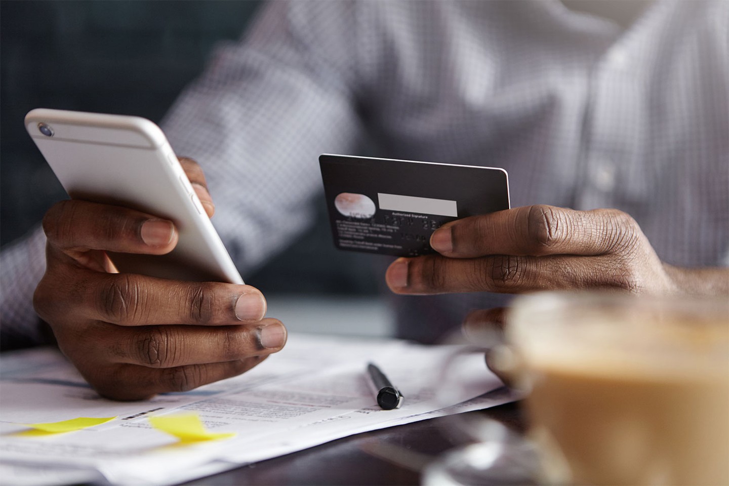 Man holding credit card and phone Man holding credit card and phone