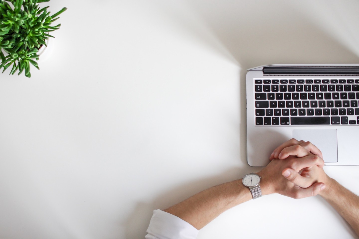 Person's hands resting near computer