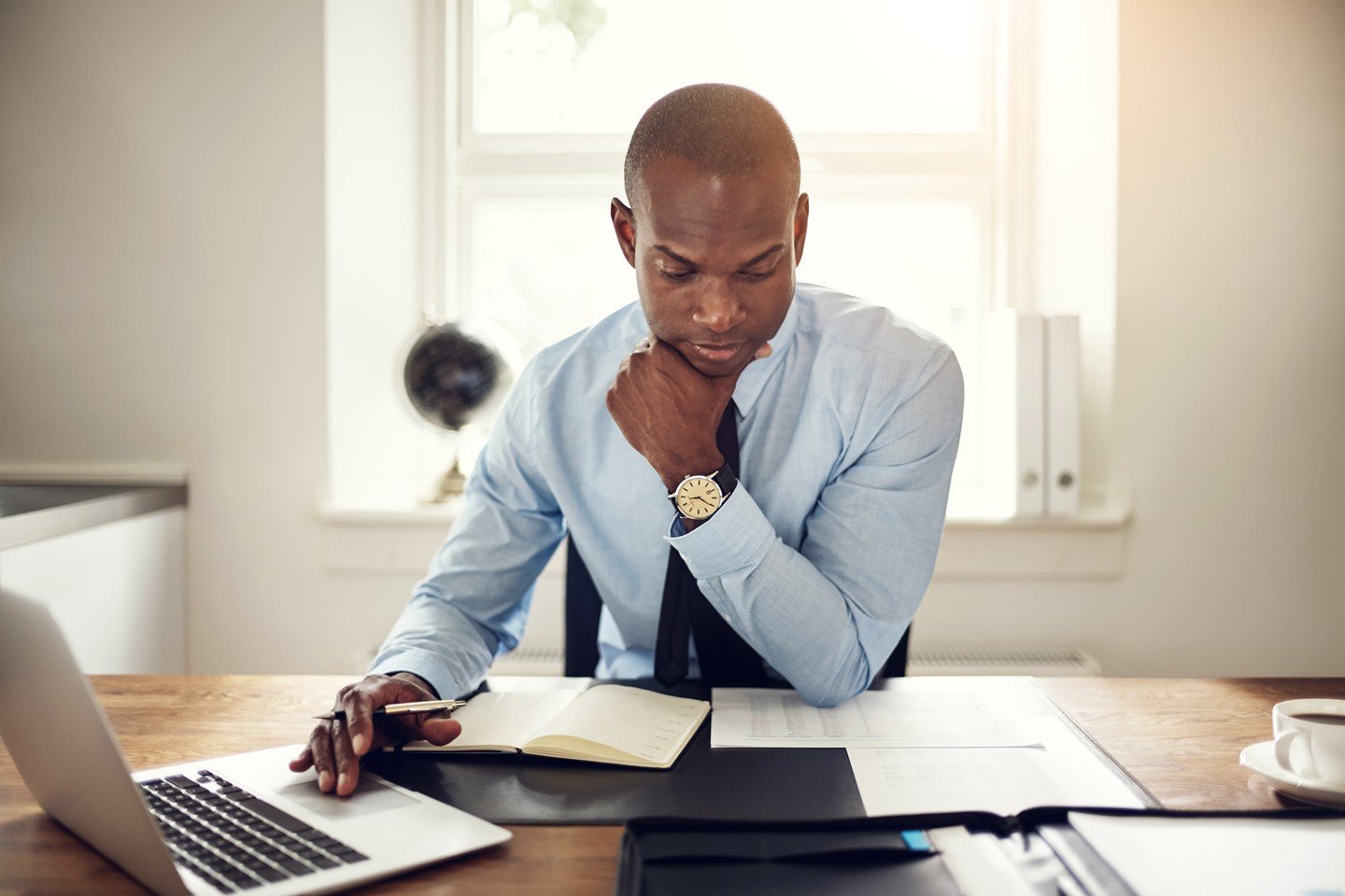 Man stressed looking down at papers Man stressed looking down at papers