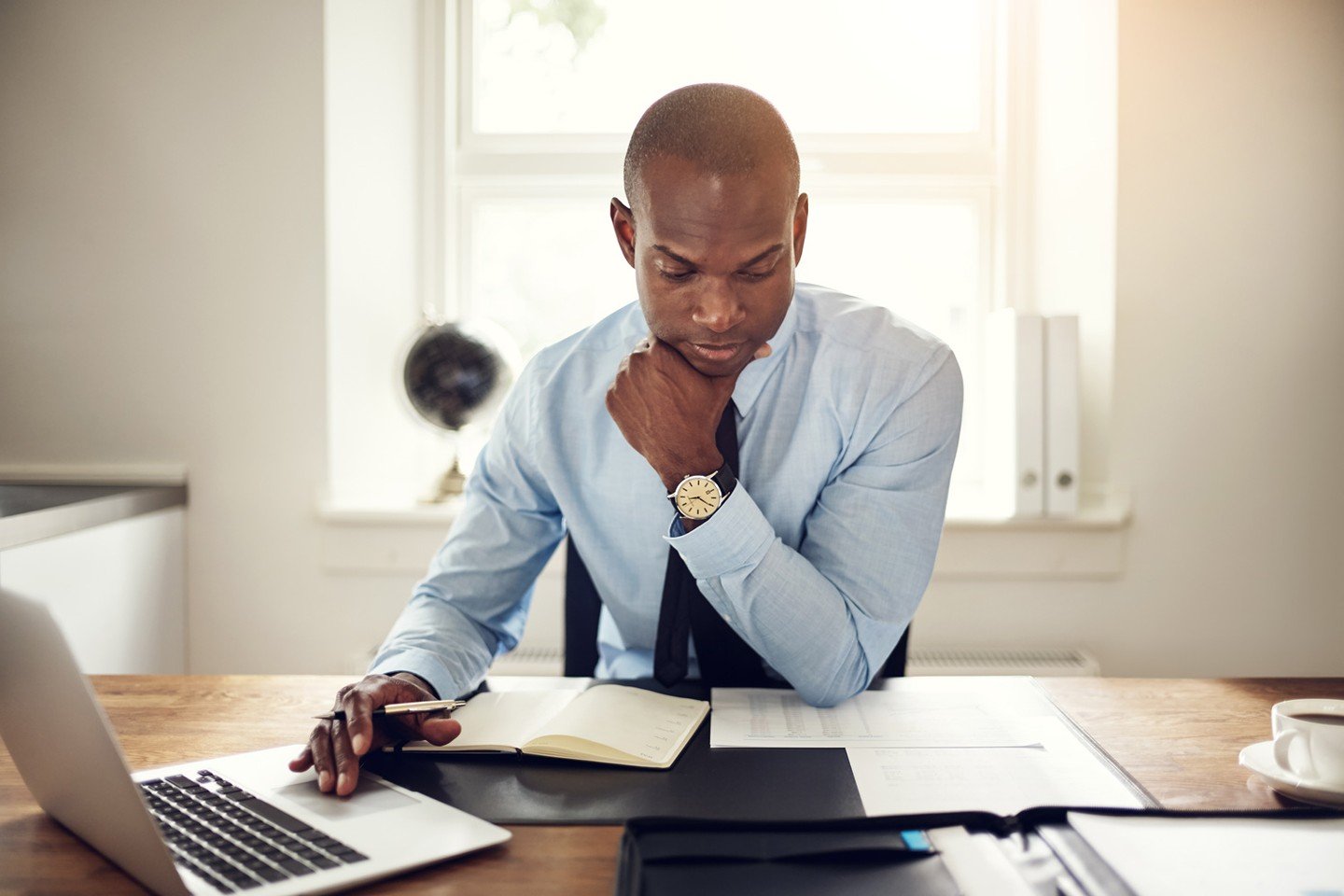 Man stressed looking down at papers