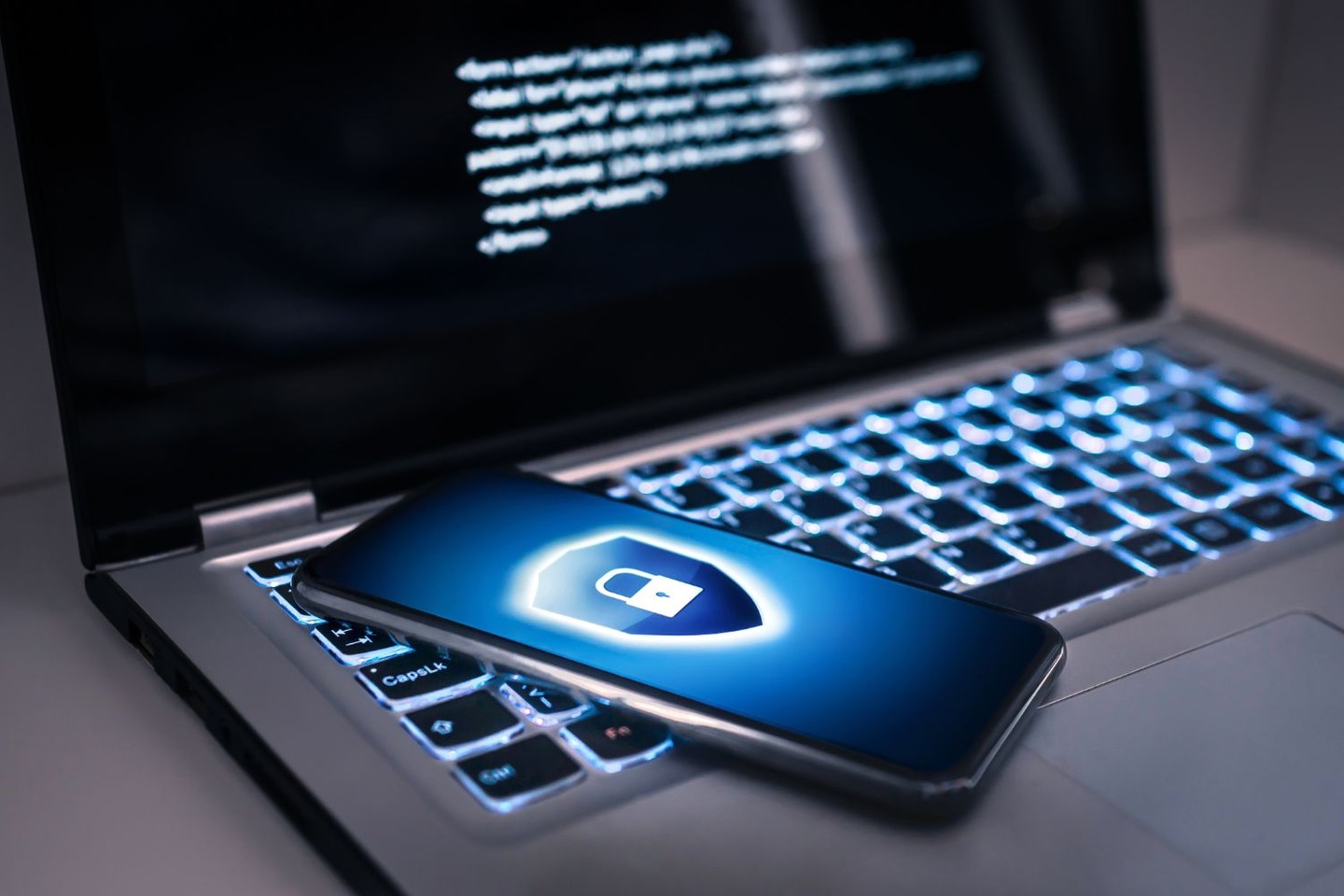 Cellphone on a laptop. Cellphone on a laptop.
