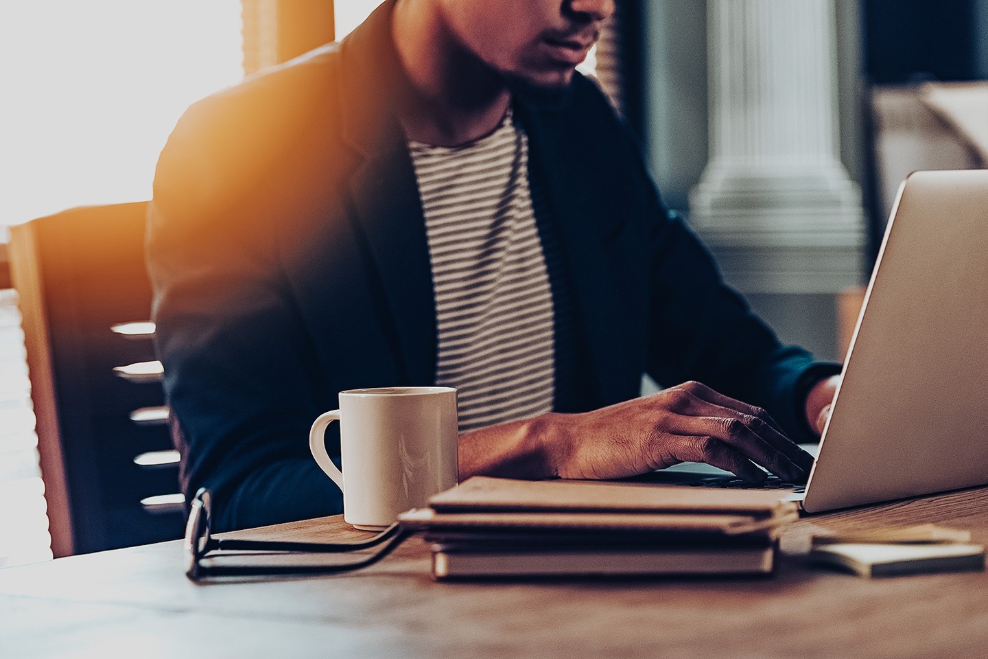 Man working on laptop with coffee