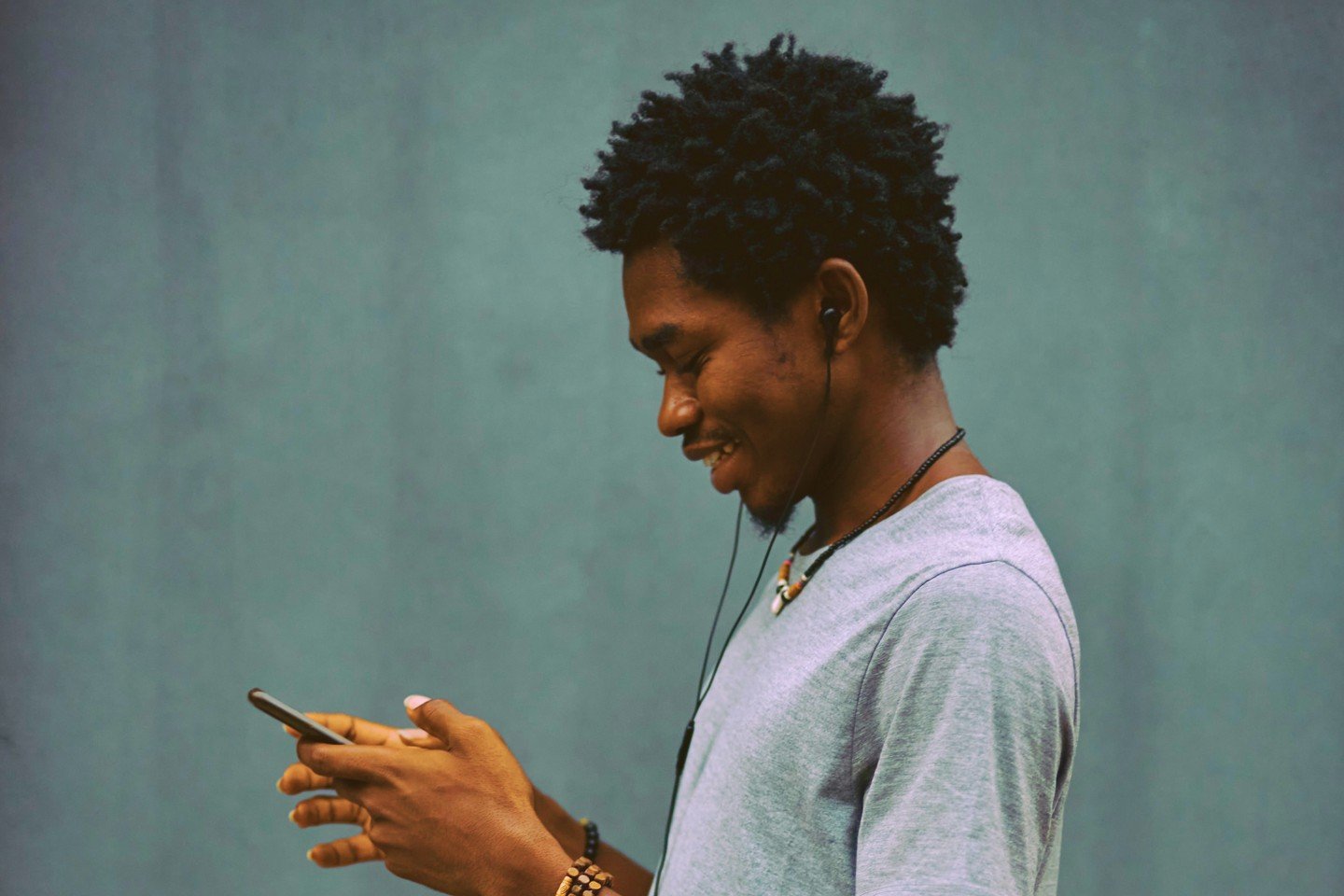 Man holding phone and smiling Man holding phone and smiling