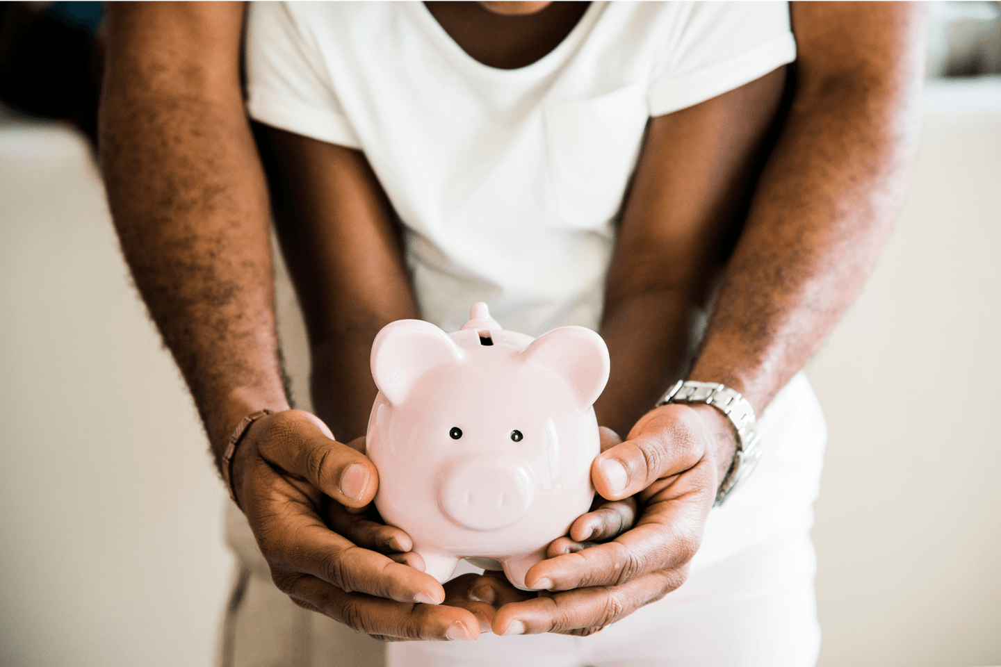 Man and child holding a piggy bank