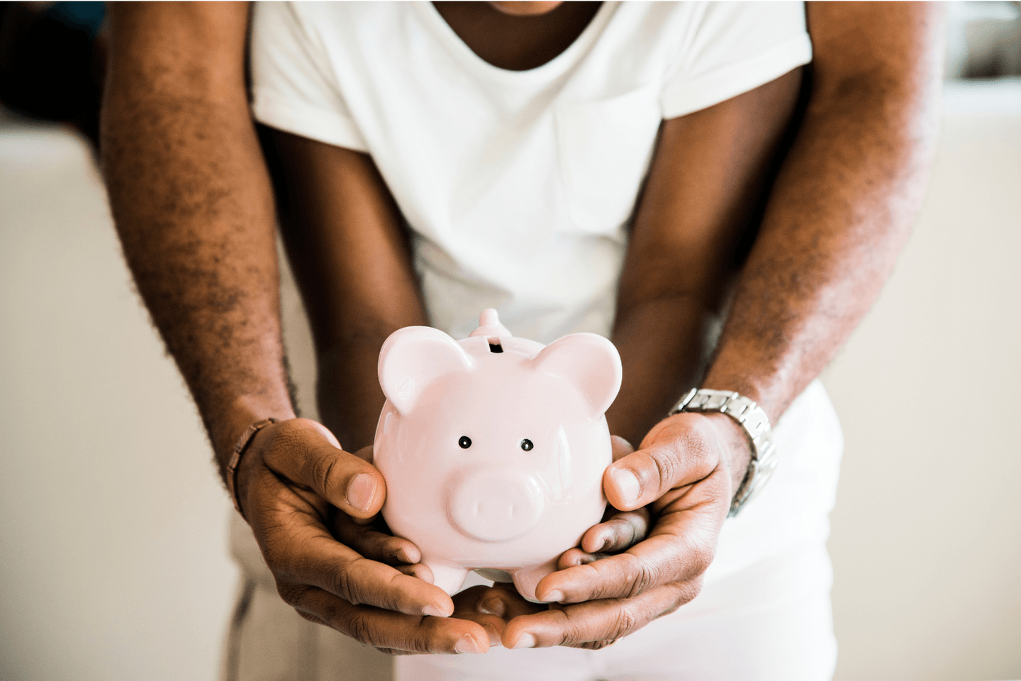 Man and child holding a piggy bank Man and child holding a piggy bank