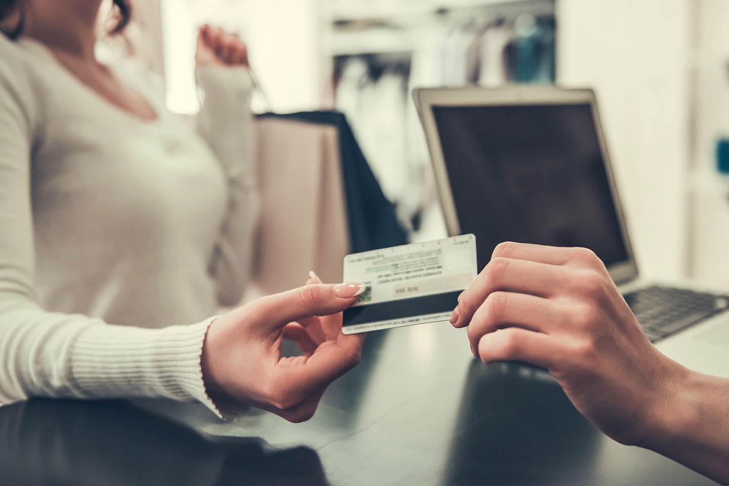 Woman paying with store card Woman paying with store card