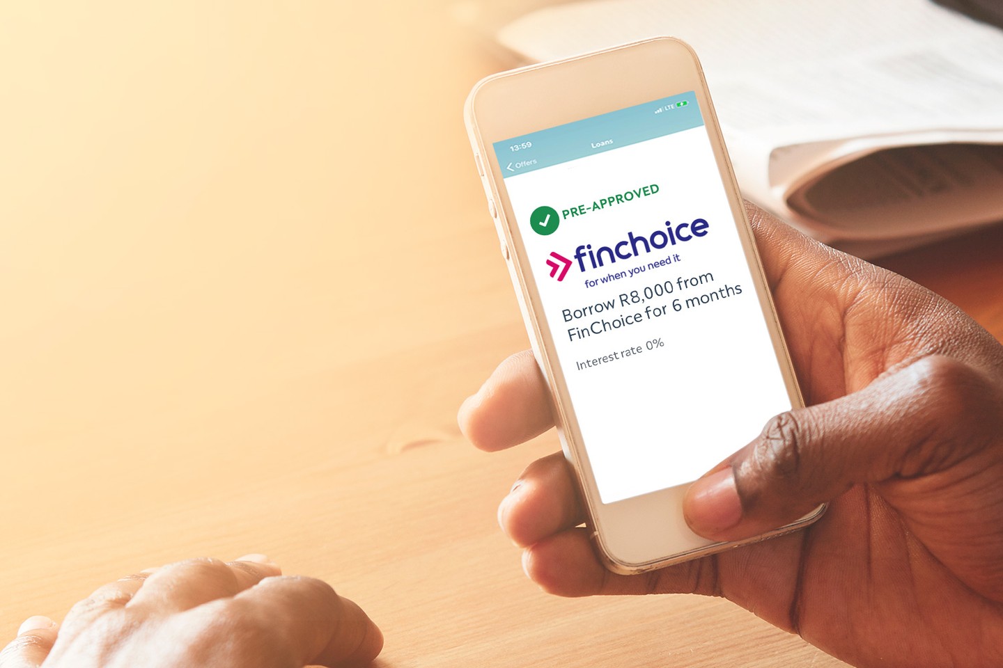 Holding phone with FinChoice loan offer