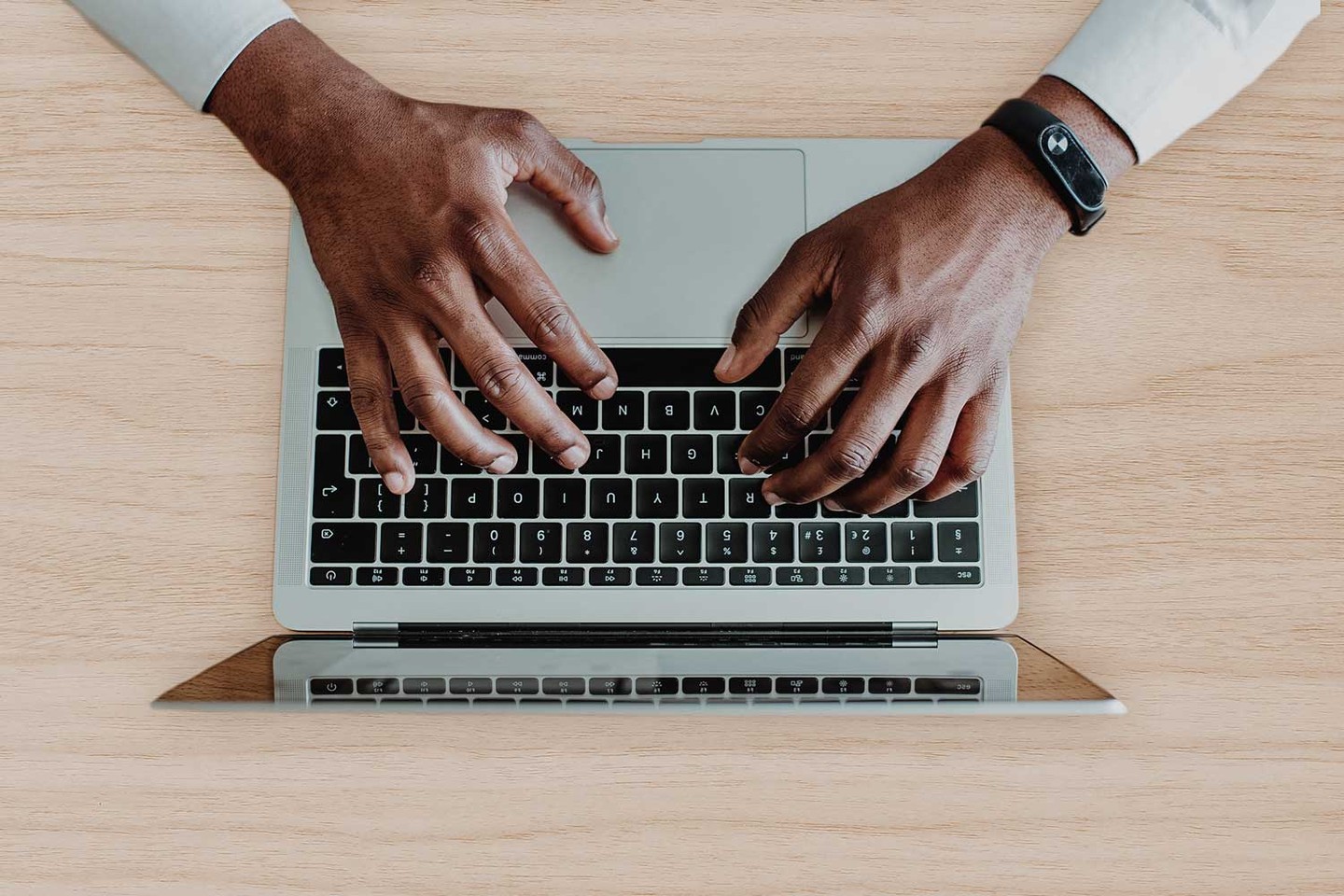 Bird's eye view man typing on laptop