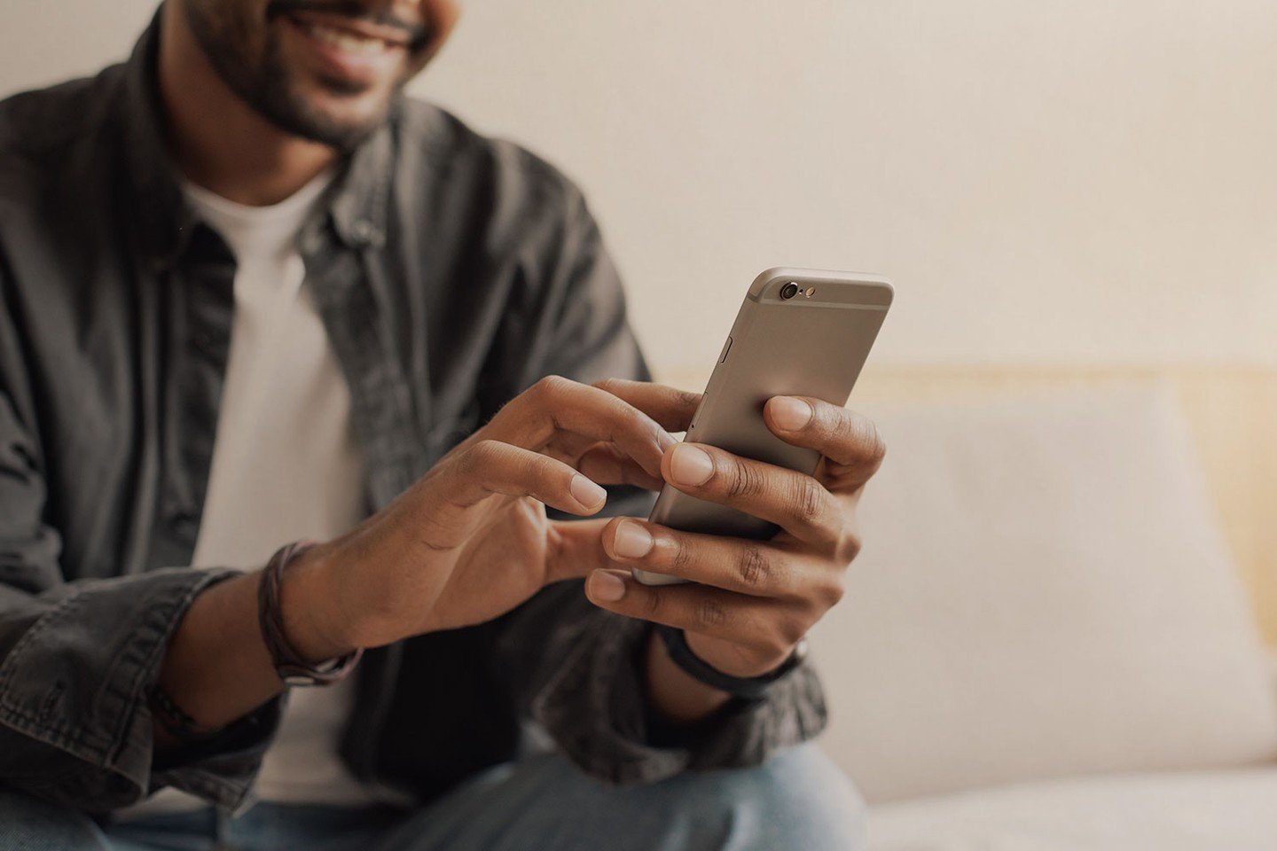 Guy smiling at phone Guy smiling at phone